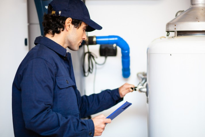 Hot water system tank with repair man
