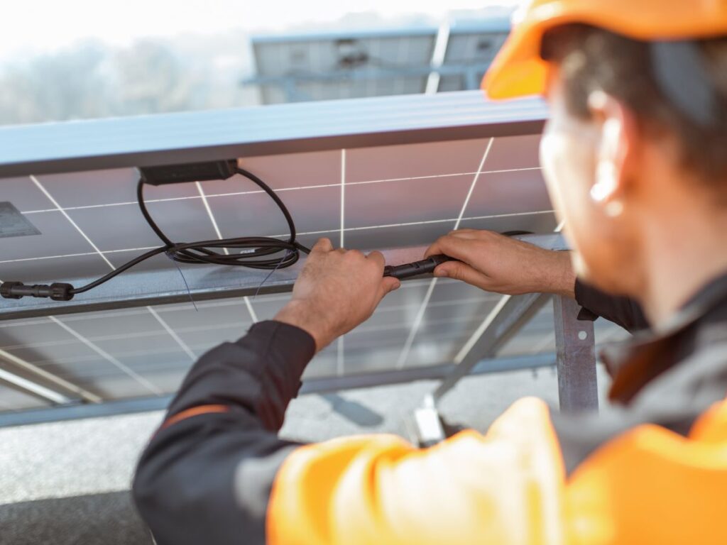 man installing a solar panel