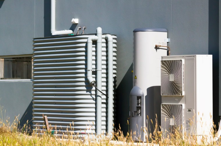 Hot water system outside next to water tank and air conditioning units