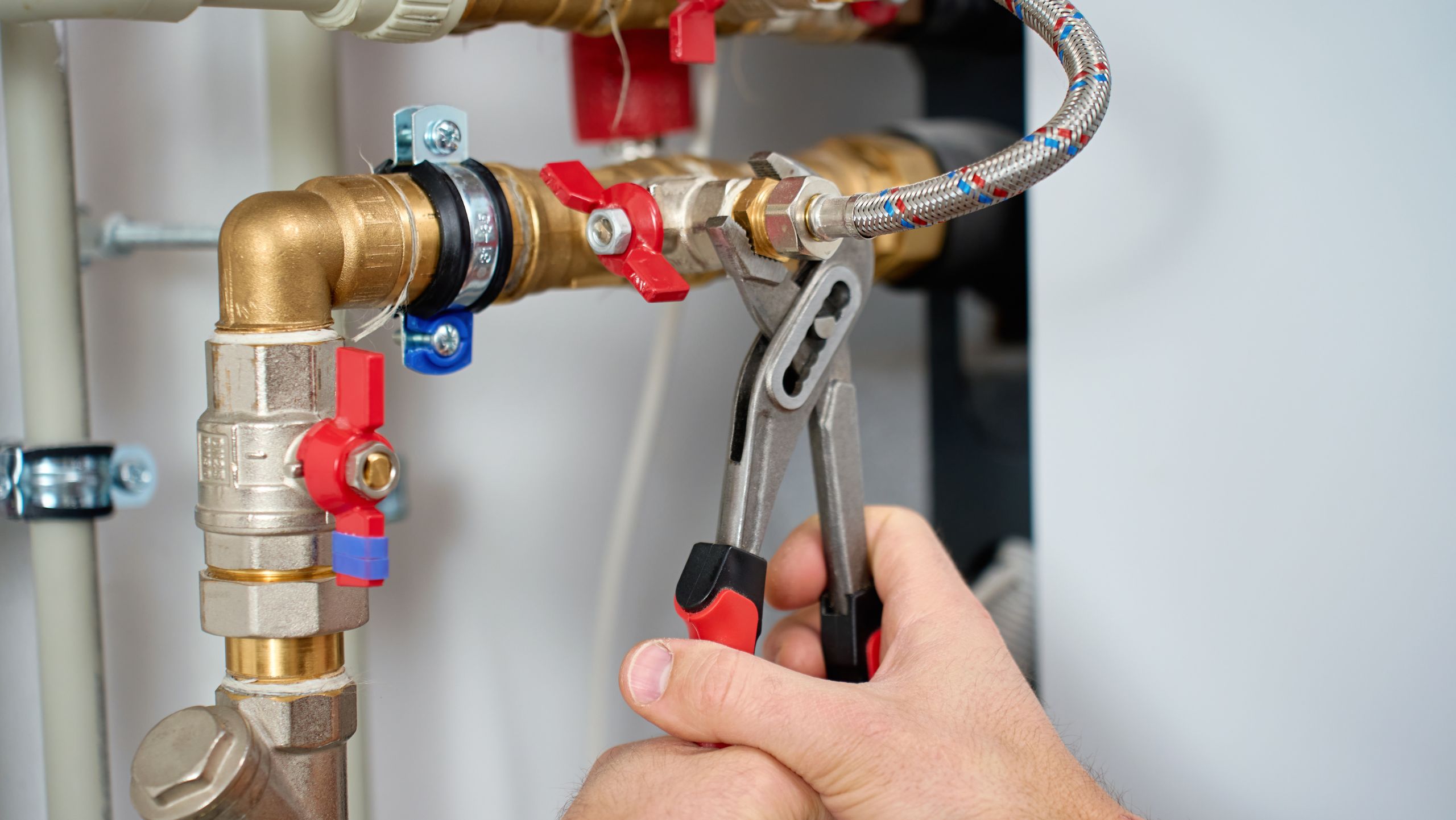 Plumber fixing water hammer in pipes
